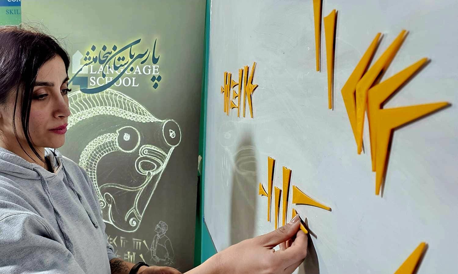 Placing golden cuneiform signs on a board